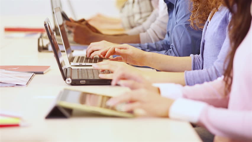 Many students typing on laptops